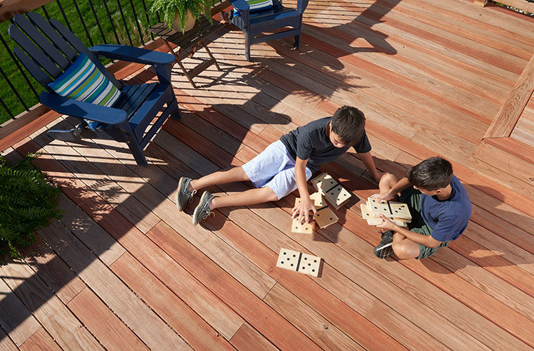ProWood Color Treated deck with kids playing outdoor dominoes