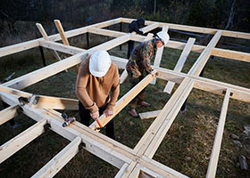 Two Men Building Deck Joists Using ProWood Pressure-Treated Lumber
