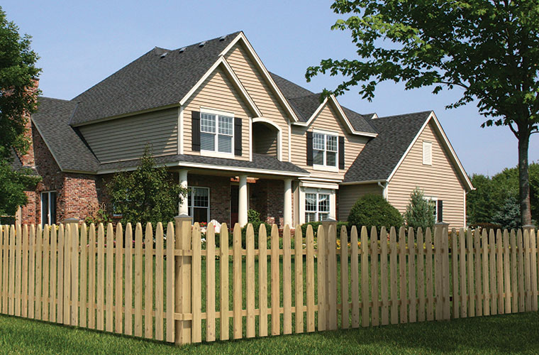 Gothic Spaced Picket Wood Fence with a traditional house in background
