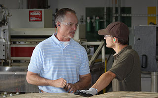 Two Wood Preservation Employees Talking in Plant